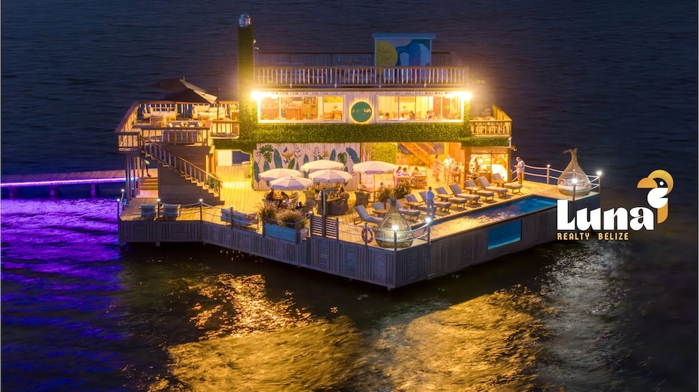 Floating restaurant with lights on water.