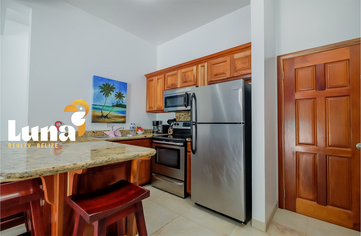Modern kitchen with wooden cabinets and appliances.