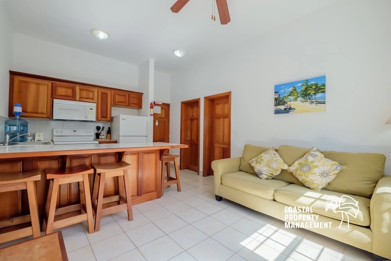 Kitchen and living area with wooden furniture.