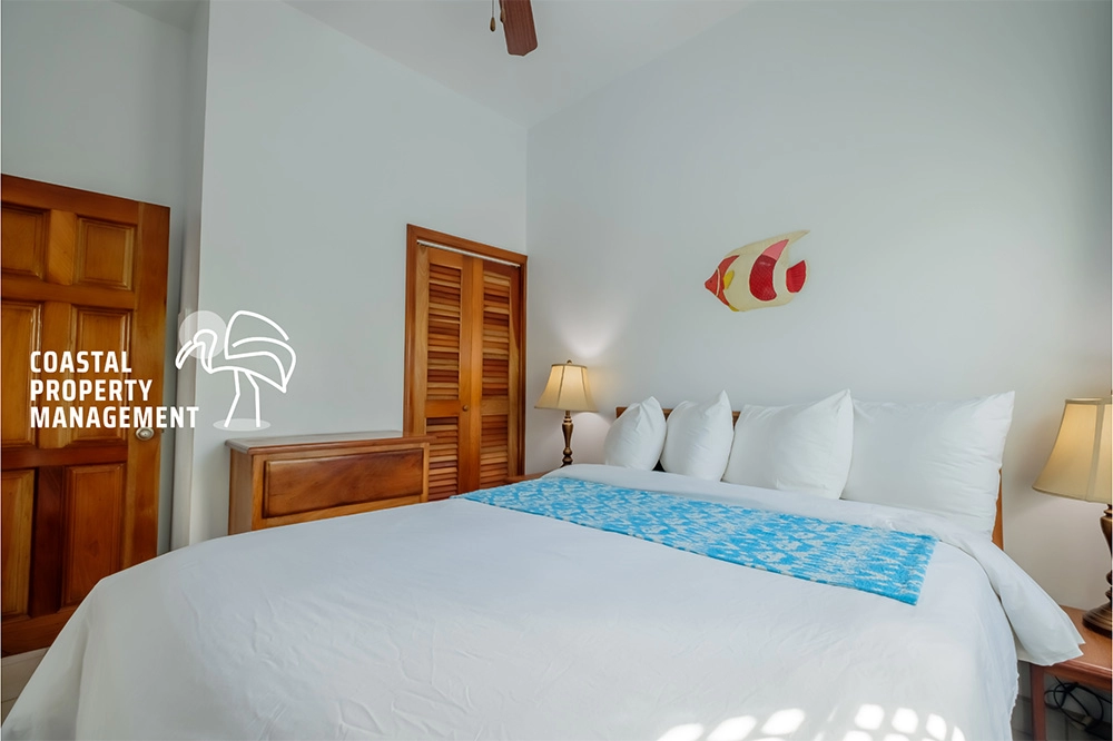 Bright bedroom with blue-accented bedding.