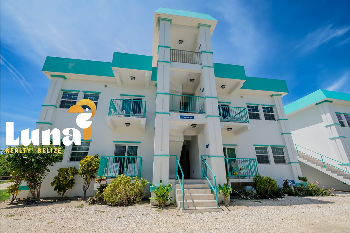 White building with teal accents and stairs.