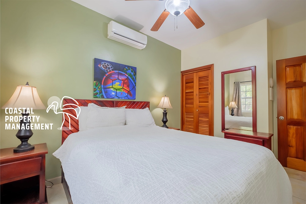 Cozy bedroom with modern decor and artwork.