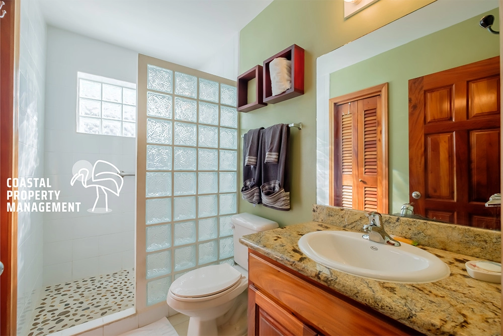 Modern bathroom with glass block shower wall.