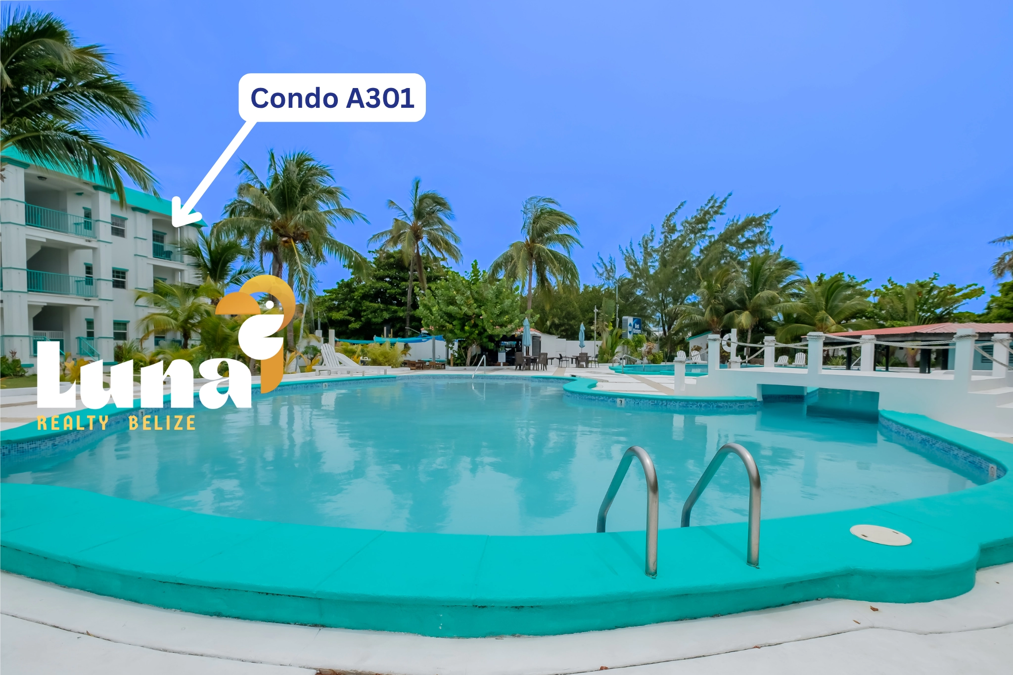 Condominium with pool and tropical surroundings.