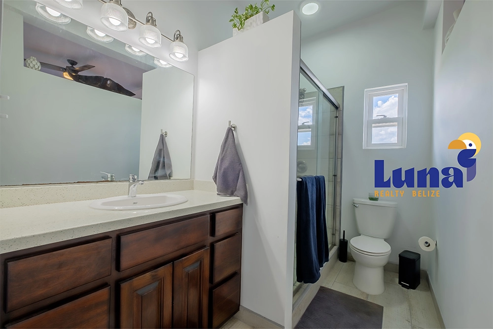 Modern bathroom with shower and wooden cabinets.