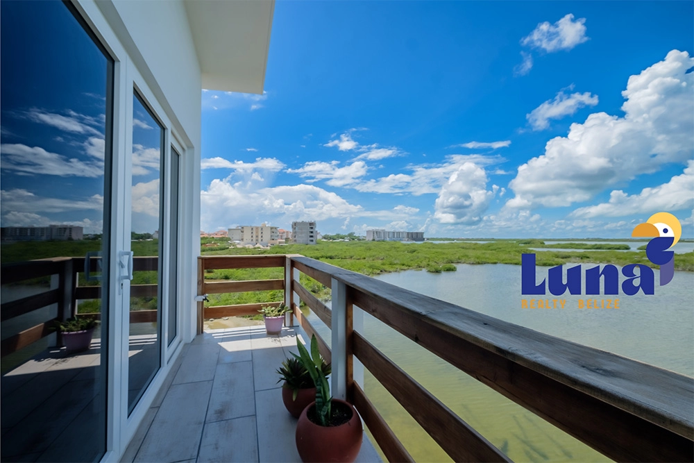 Balcony view of blue sky and water.