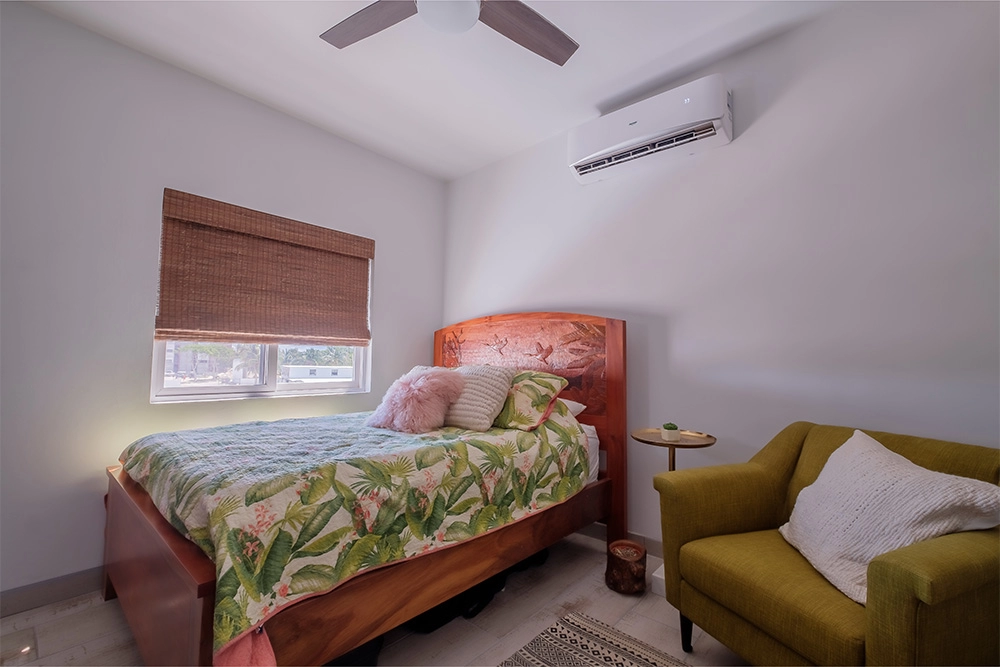Cozy bedroom with tropical-themed bedding.