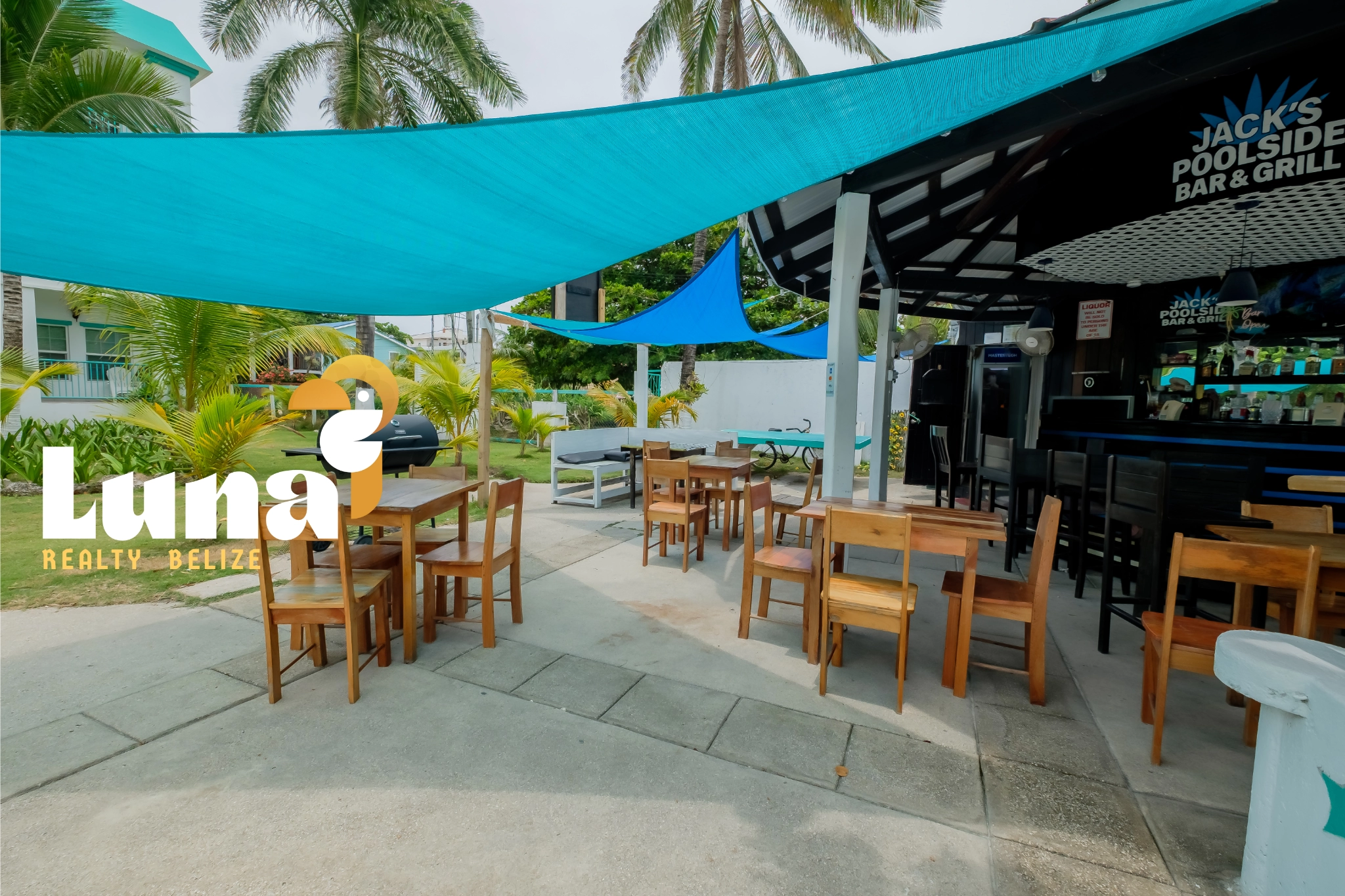 Outdoor bar and grill with seating area.