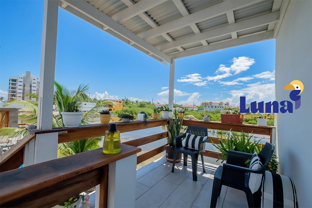 Rooftop terrace with chairs and plants.