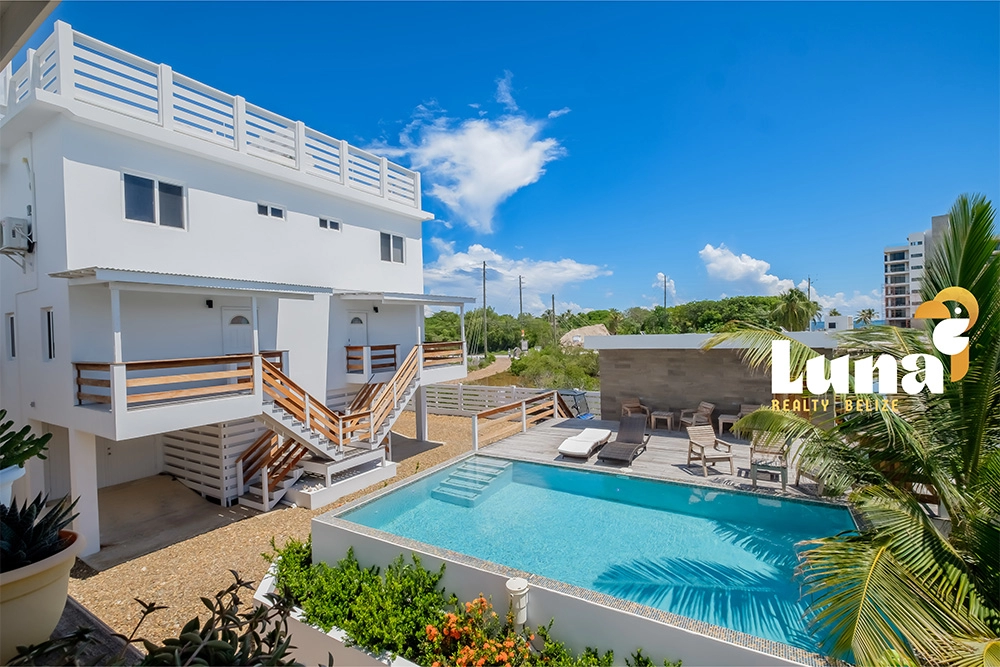 Modern house with pool and blue sky.