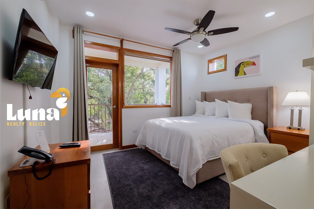 Bright bedroom with balcony and modern decor.