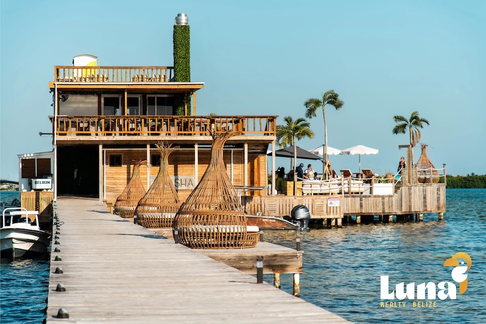Dock leading to overwater restaurant with seating.