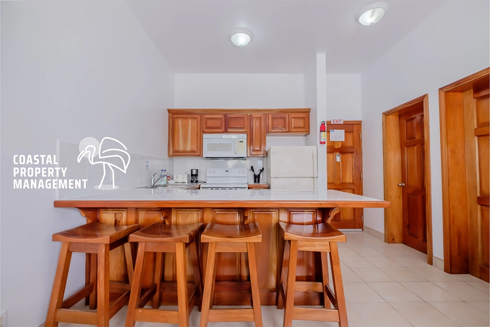 Kitchen with wooden stools and cabinets.