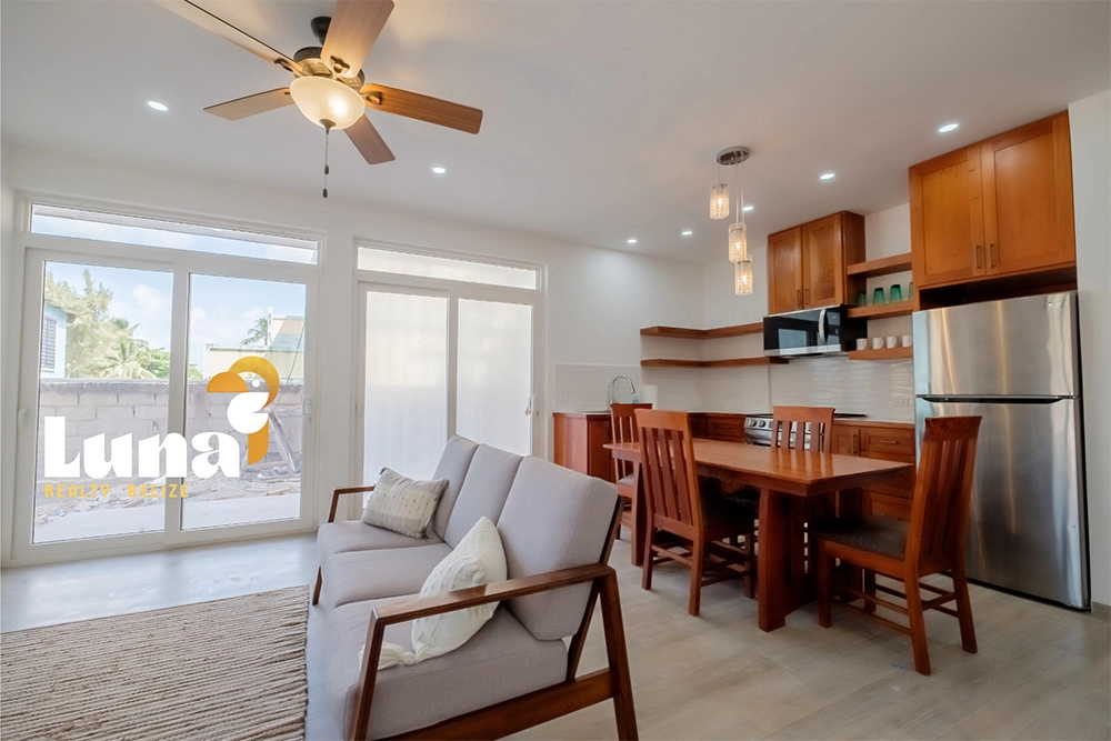 Modern living room and kitchen with wooden furniture.