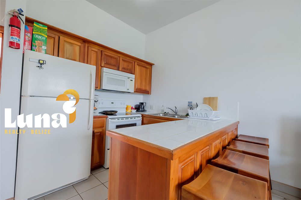 Kitchen with wooden cabinets and island counter.