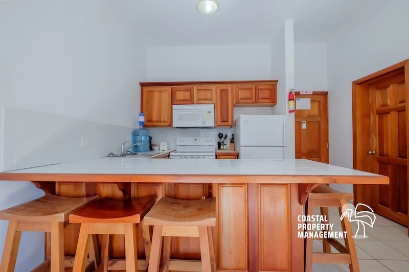 Kitchen with wooden cabinets and stools.