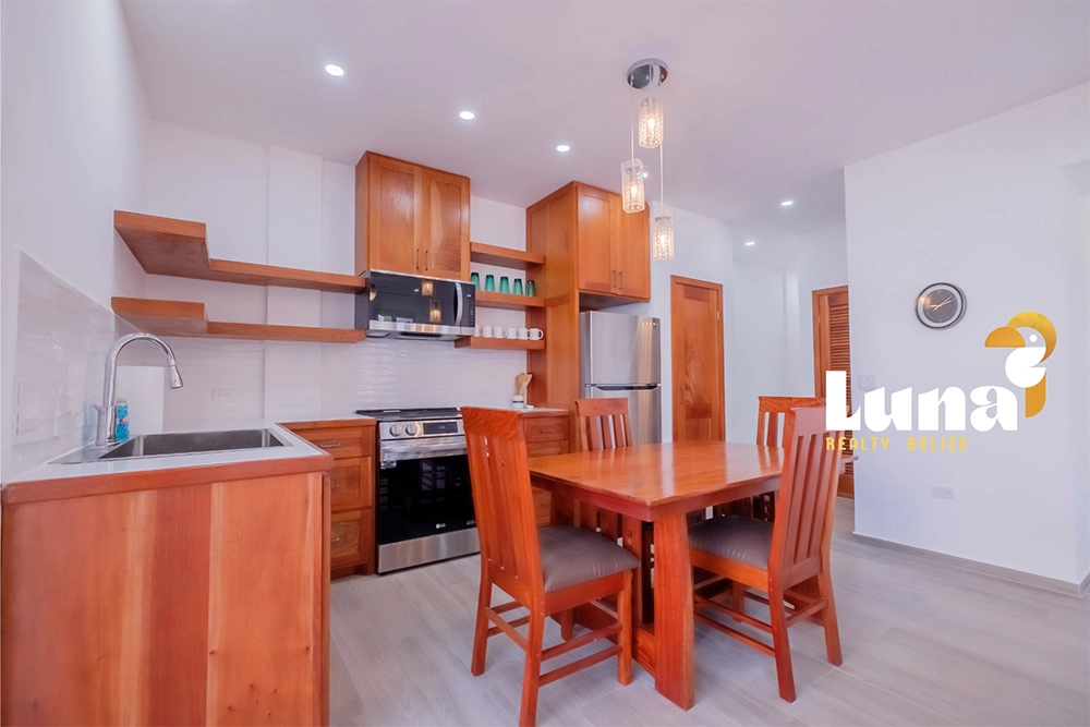 Modern kitchen with wooden furniture and appliances.