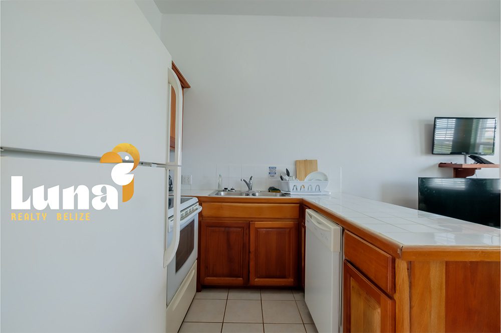 Kitchen with wooden cabinets and appliances.