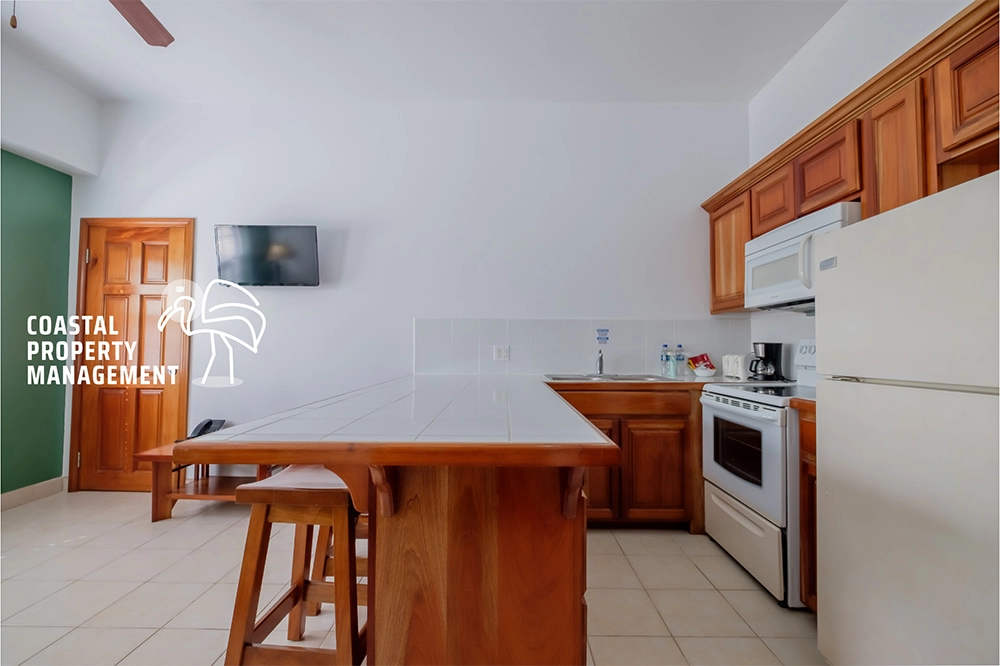 Kitchen interior with wooden cabinets and island.