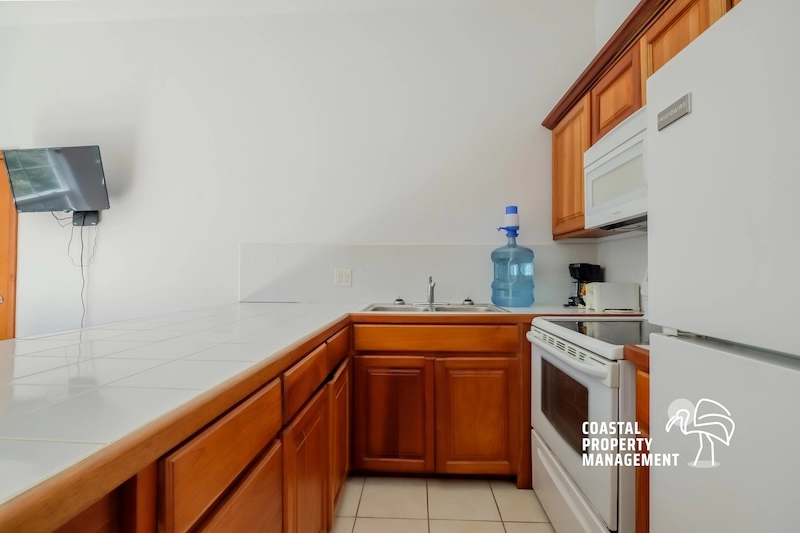 Wooden kitchen with appliances and countertop.