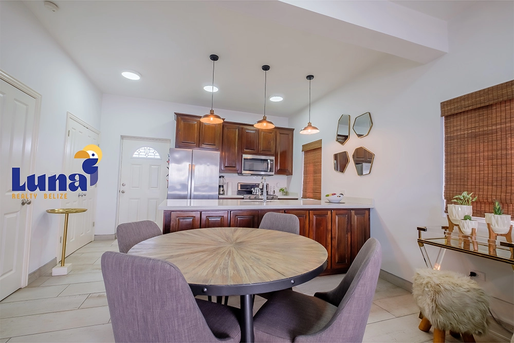Modern kitchen with dining table and chairs.