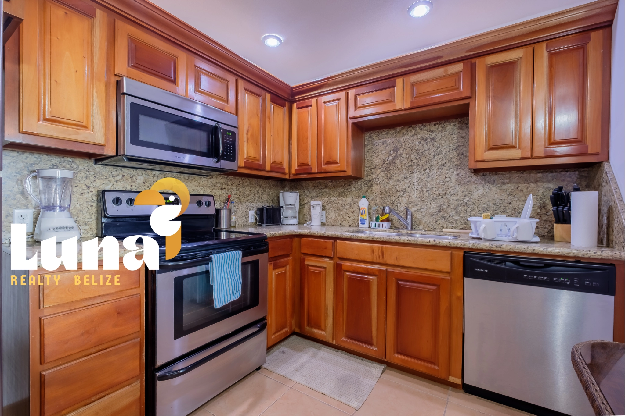 Modern kitchen with wooden cabinets and appliances.