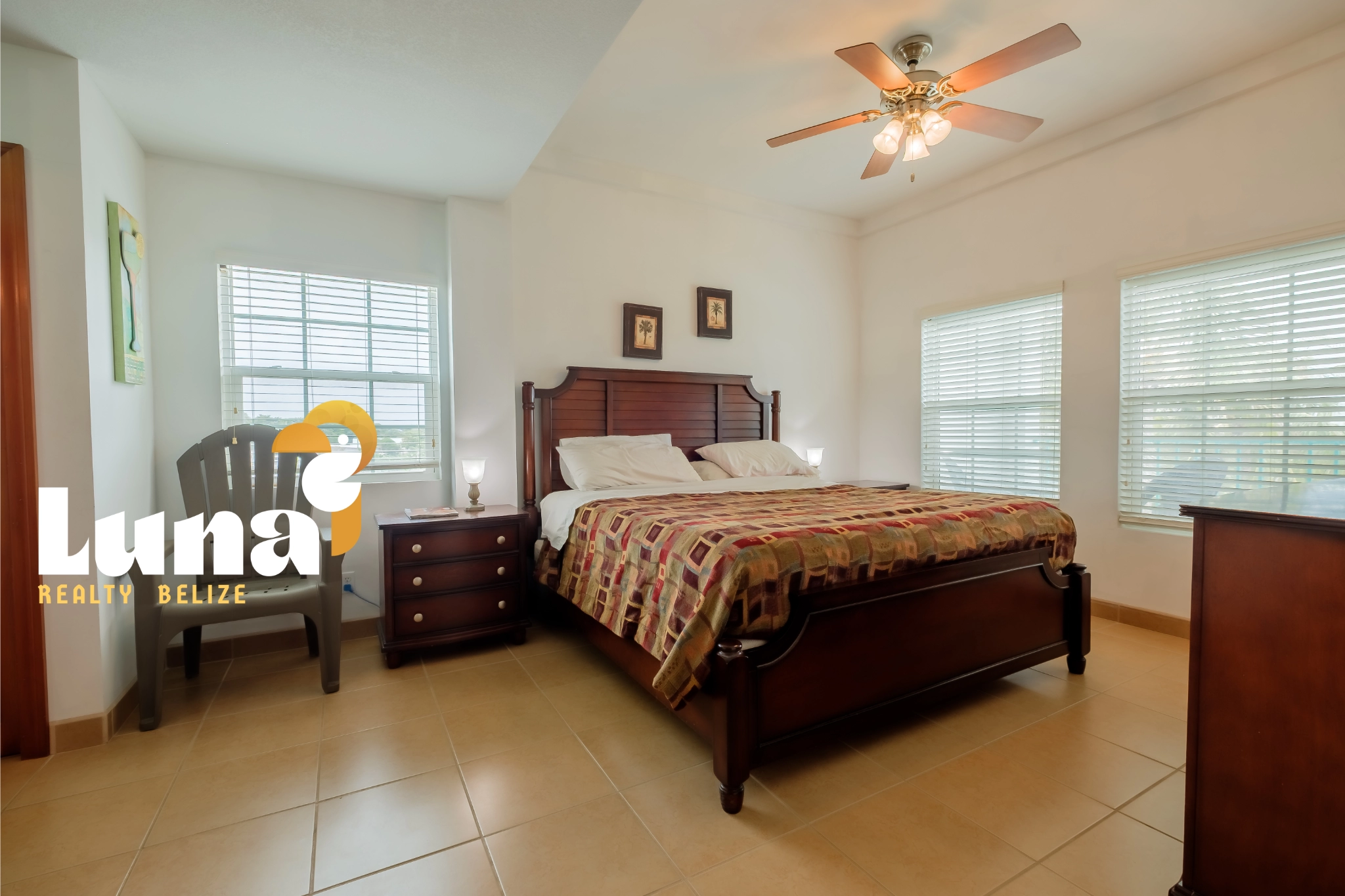 Bedroom with wooden furniture and ceiling fan.