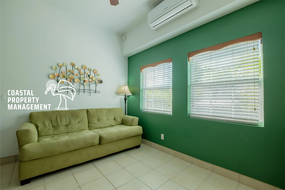 Green sofa in a bright living room.