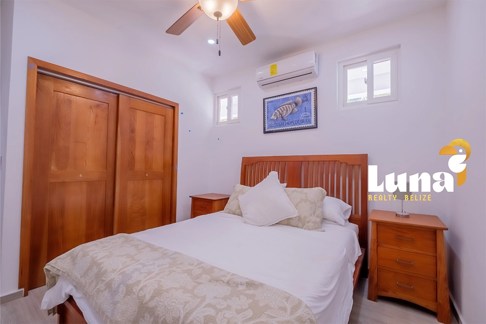 Cozy bedroom with wooden furniture and artwork.