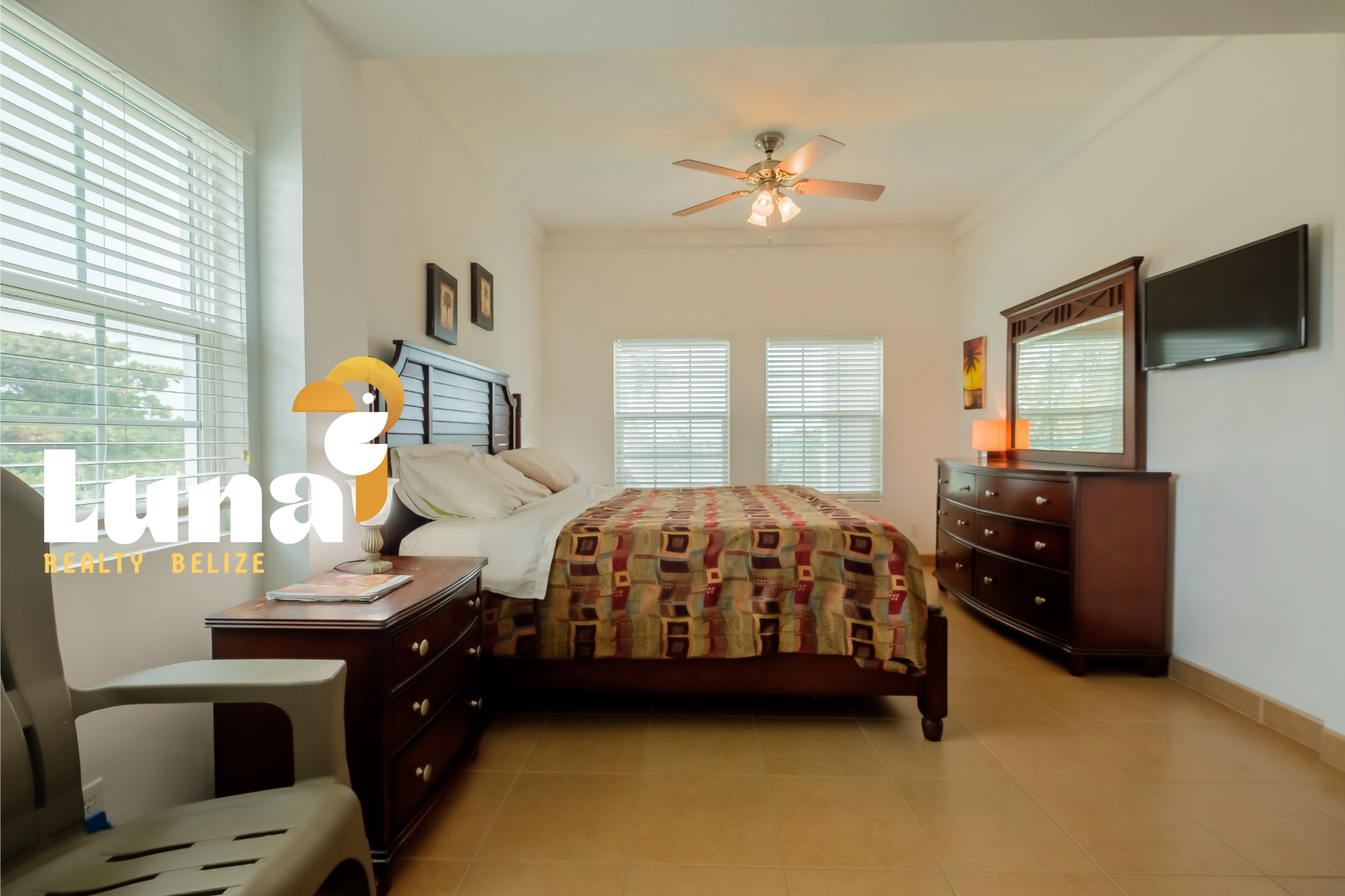 Bedroom with wooden furniture and ceiling fan.