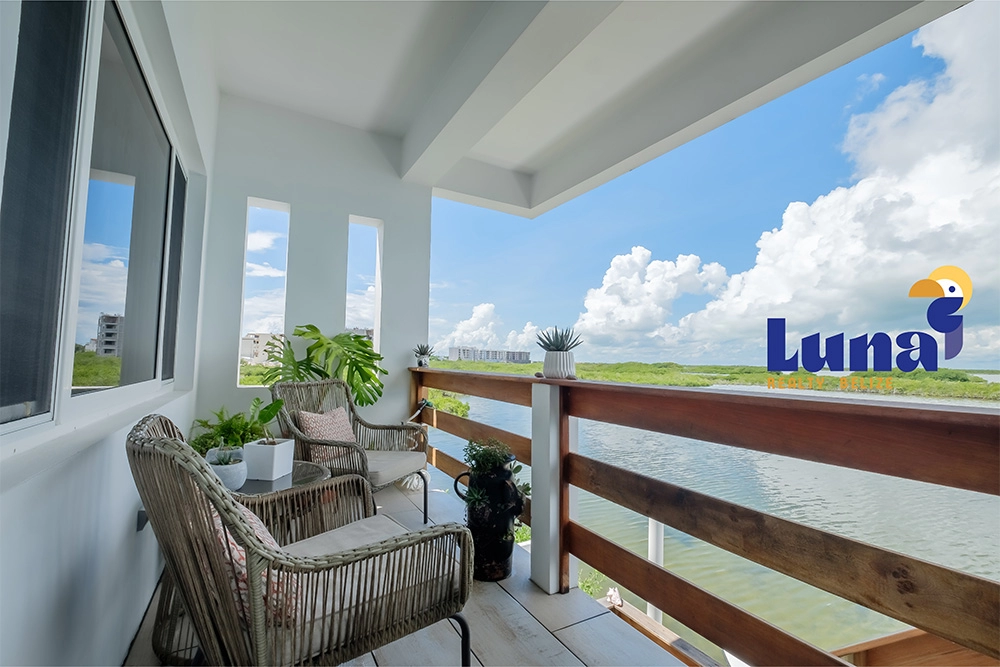 Balcony with chairs overlooking scenic view.