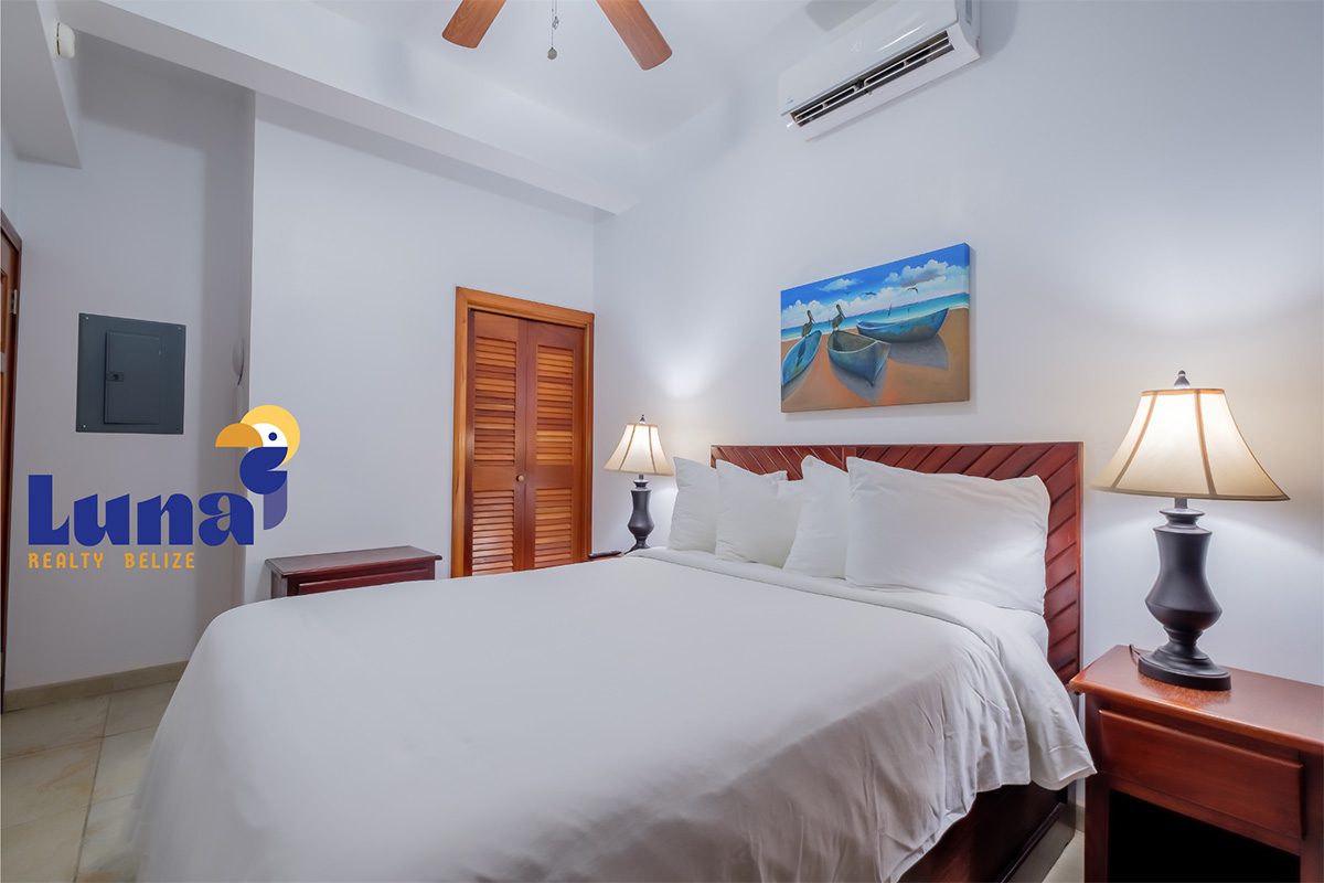 Cozy bedroom with double bed and lamps.