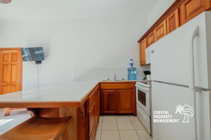 Modern kitchen with wooden cabinets and appliances.