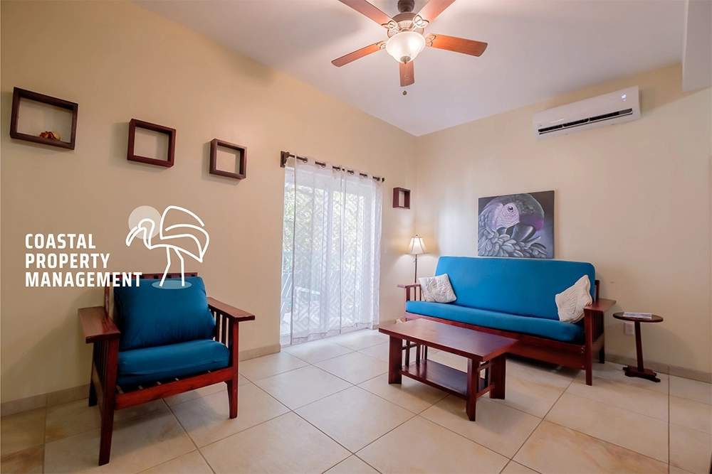 Living room with blue furniture and decor.