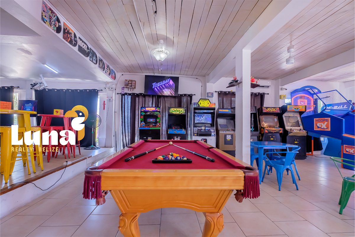 Arcade room with pool table and games.