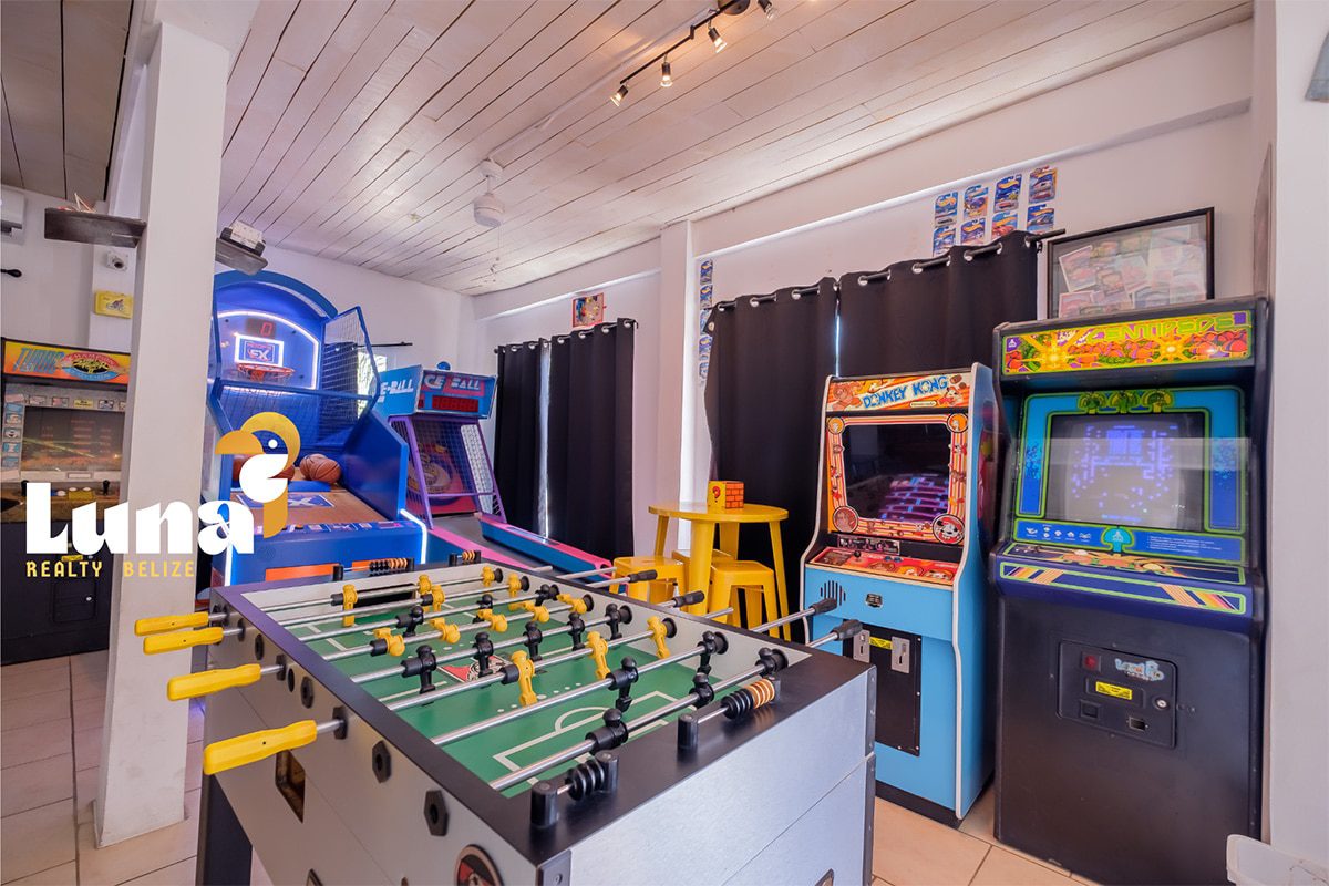 Arcade room with games and foosball table.