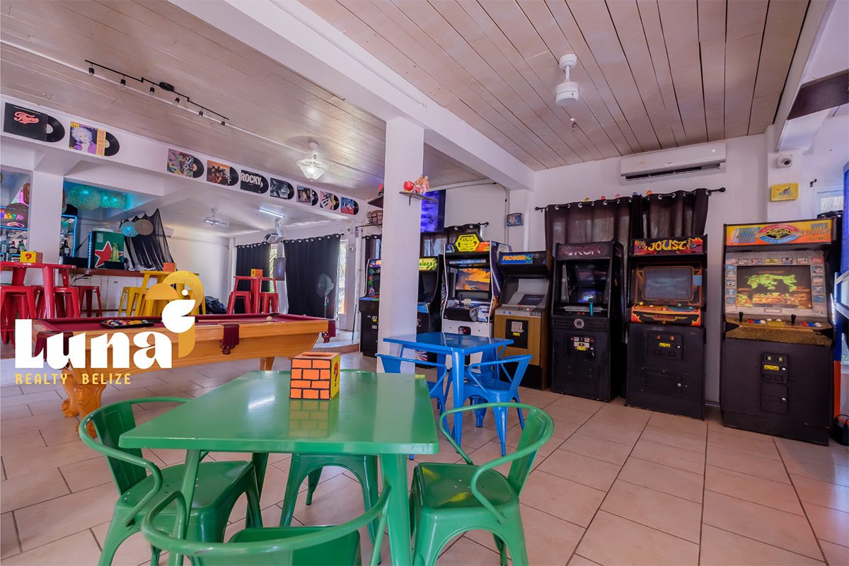 Arcade with colorful tables and retro games.