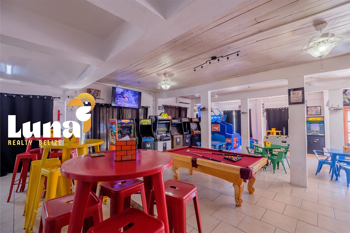 Game room with arcade machines and pool table.