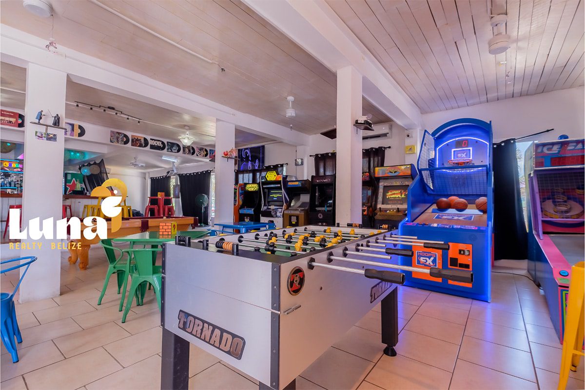 Arcade room with games and foosball table.