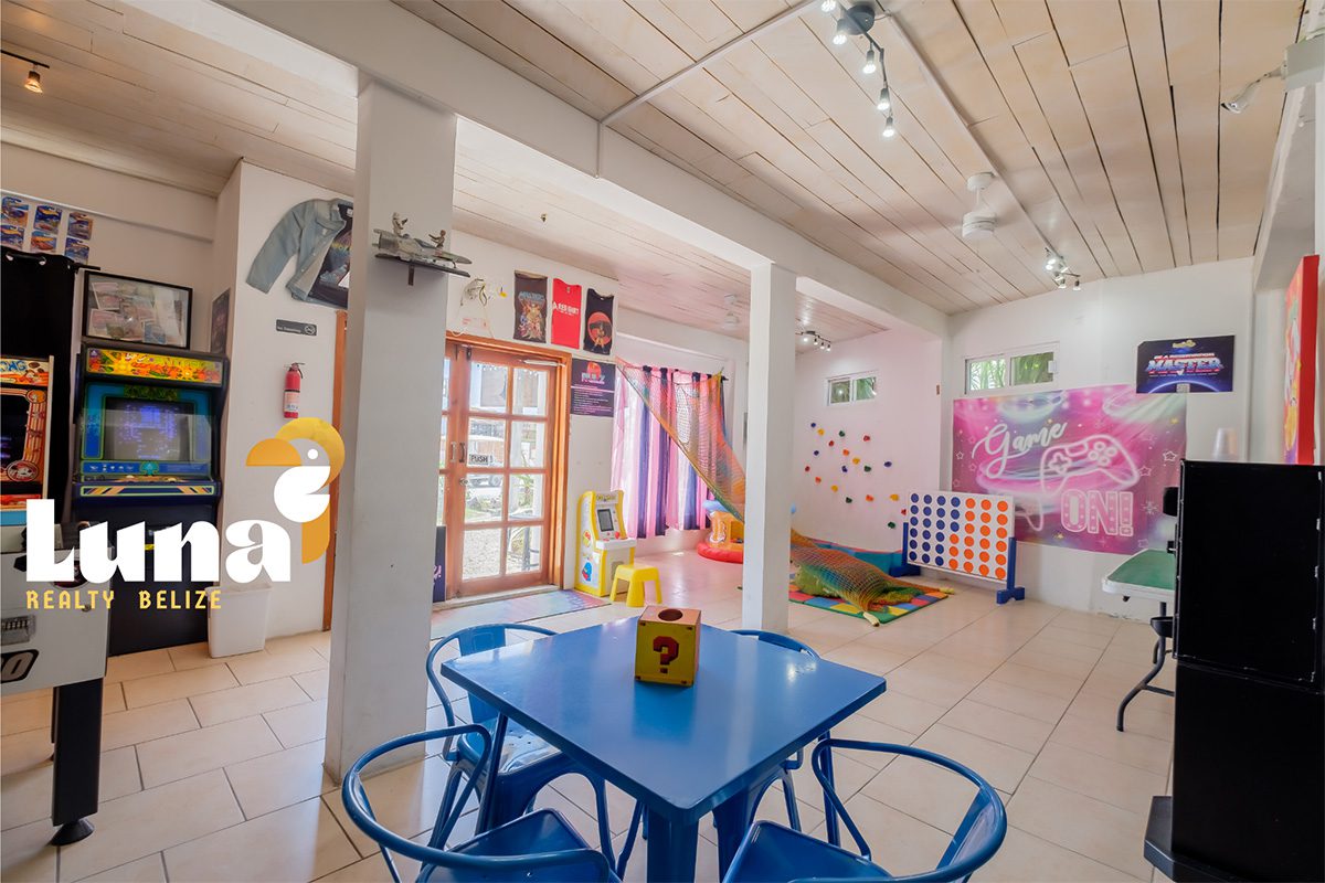 Colorful indoor playroom with games and seating.
