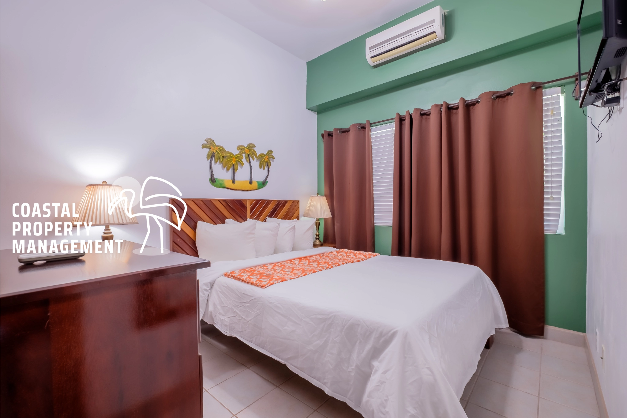 Cozy bedroom with green accents and decor.