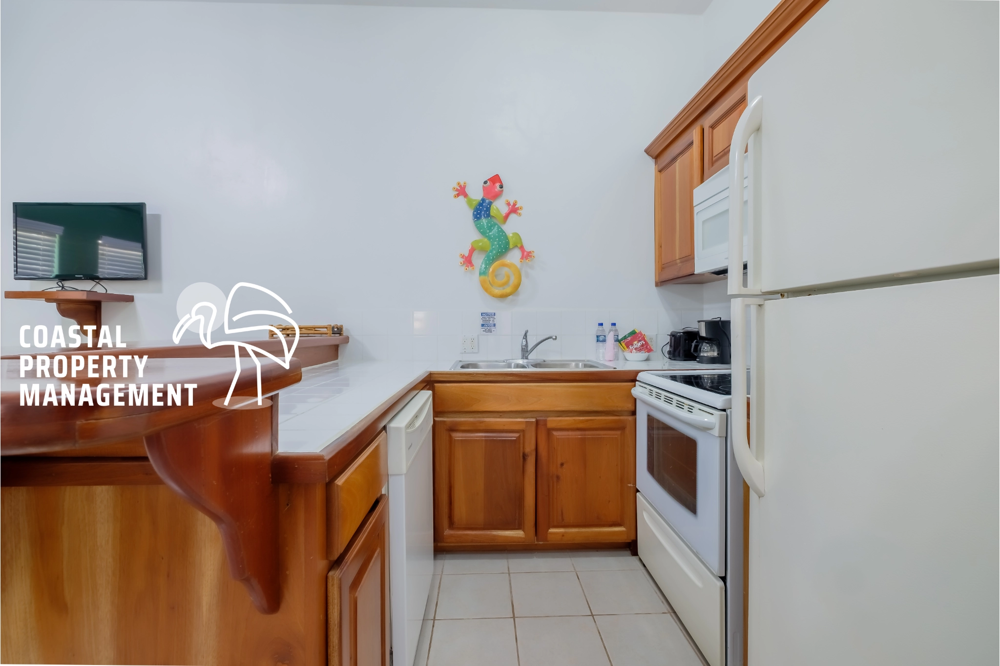 Kitchen with wooden cabinets and colorful decor.