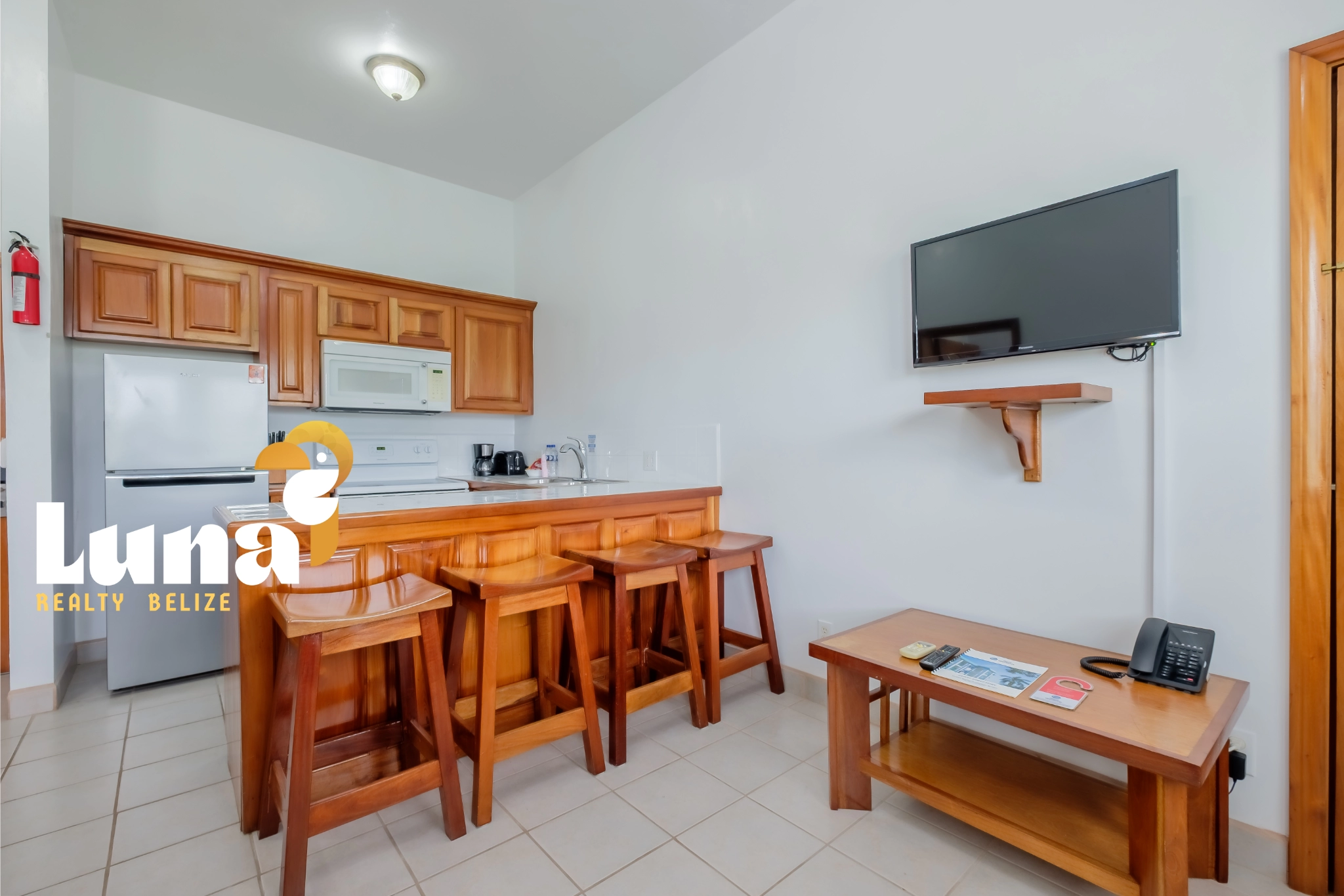 Kitchen and living area with wooden furniture.