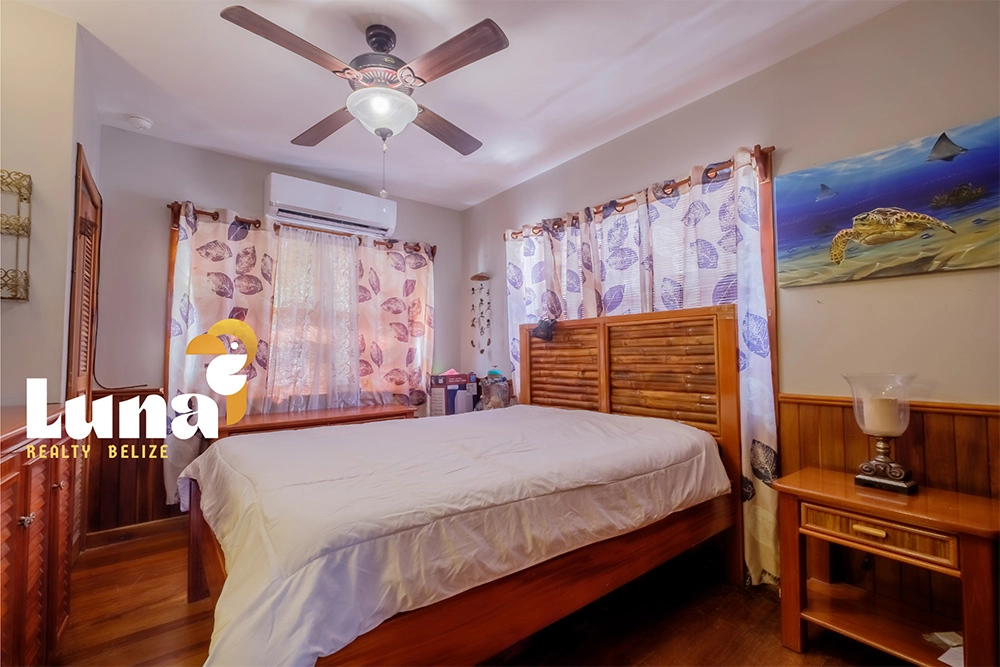 Cozy bedroom with wooden furniture and decor.
