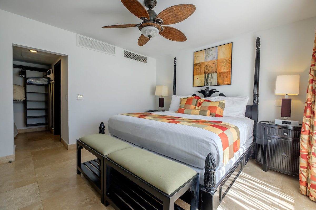 Hotel room with bed and ceiling fan.