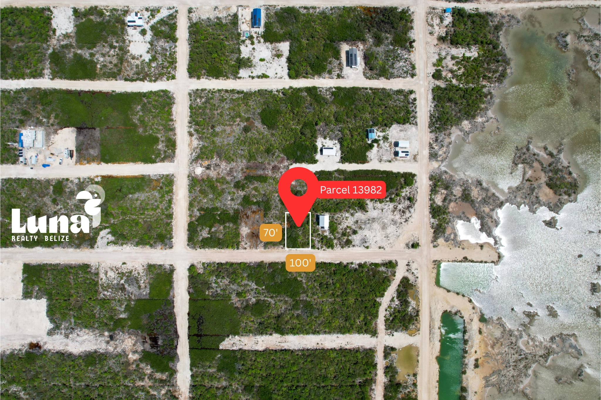 Aerial view of land plot with marker.