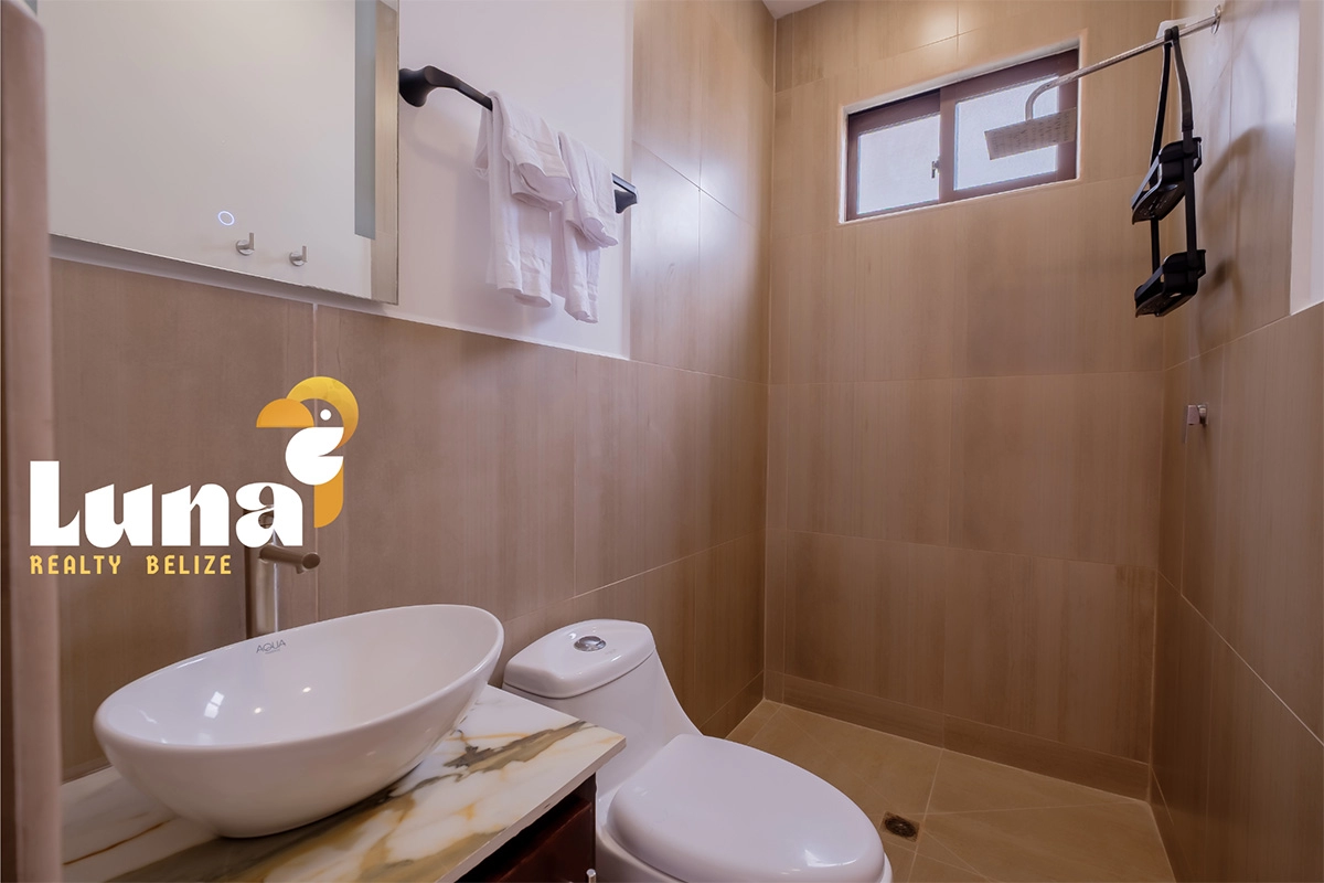 Modern bathroom with sink and toilet.