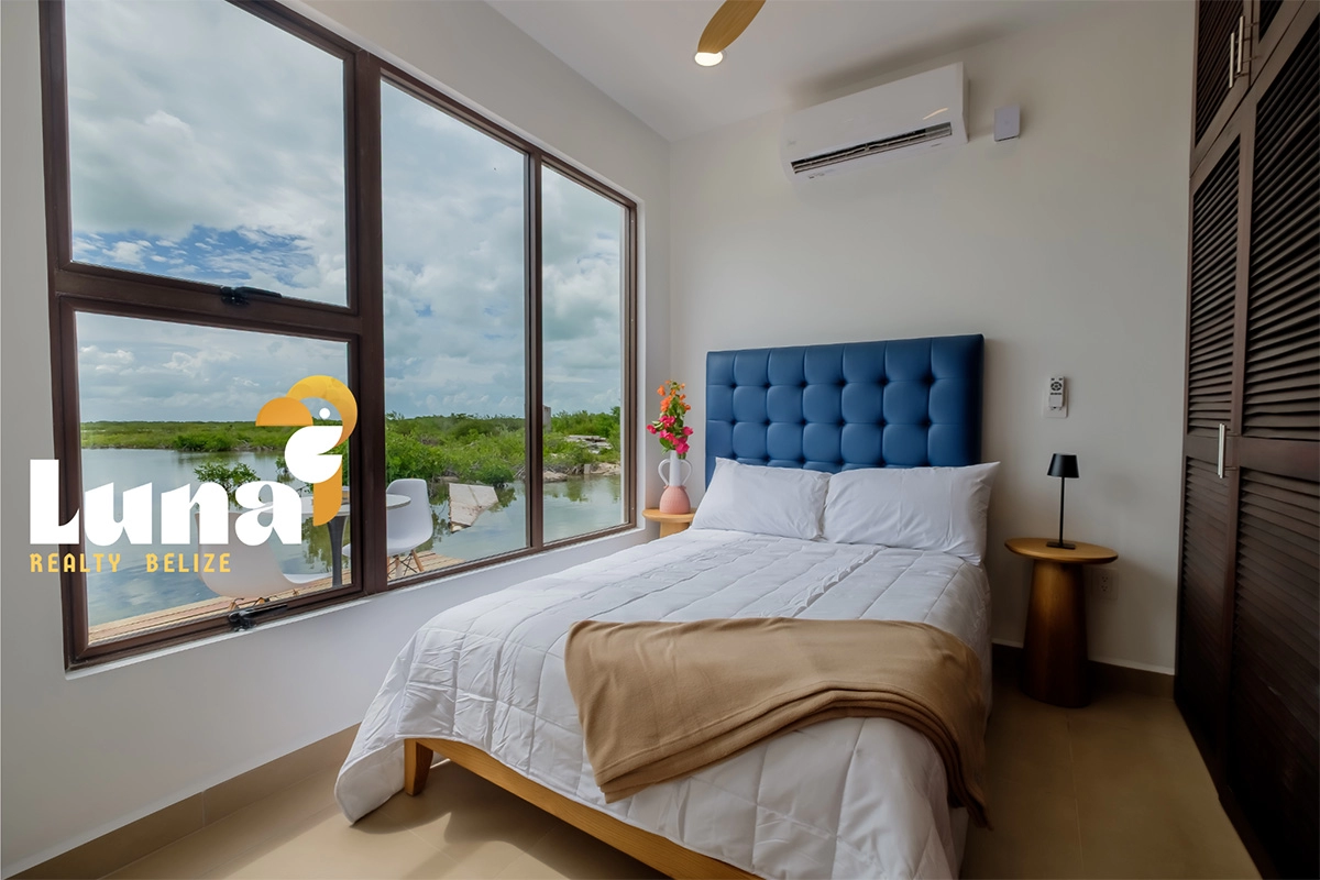 Bedroom with large window and scenic view.