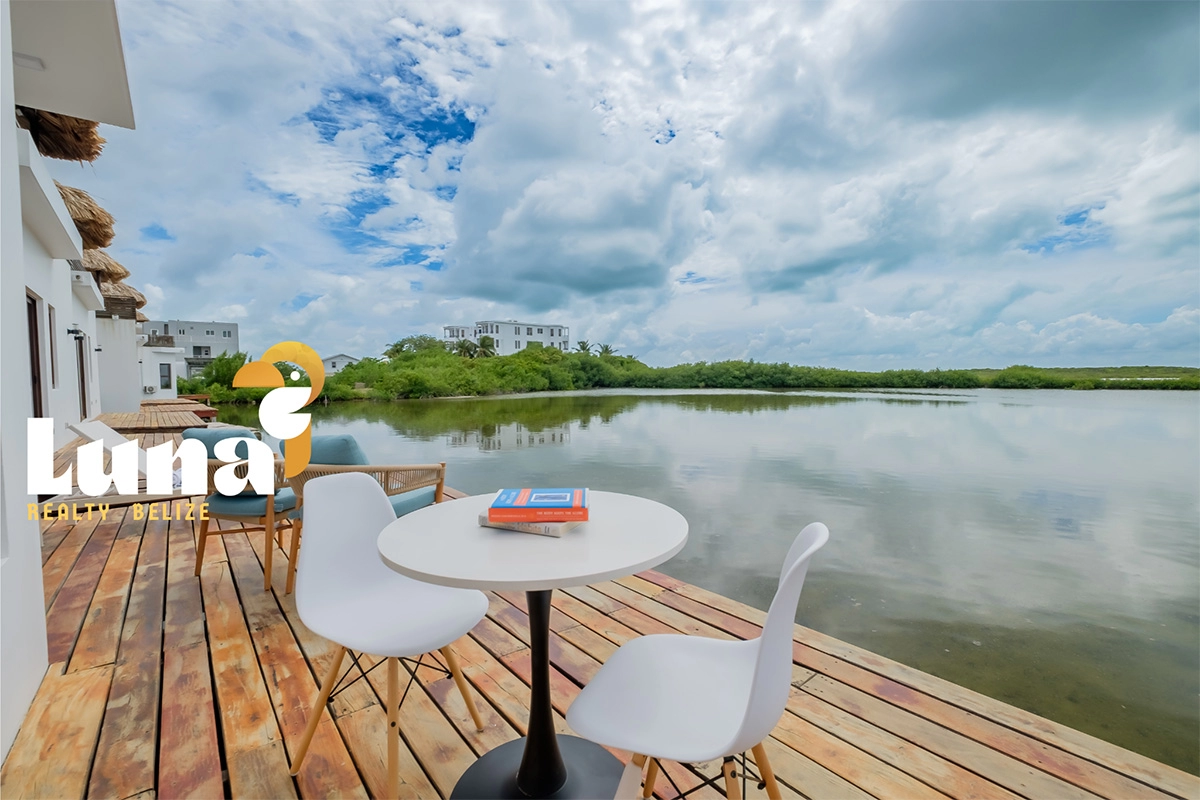 Lakeside patio with chairs and table.