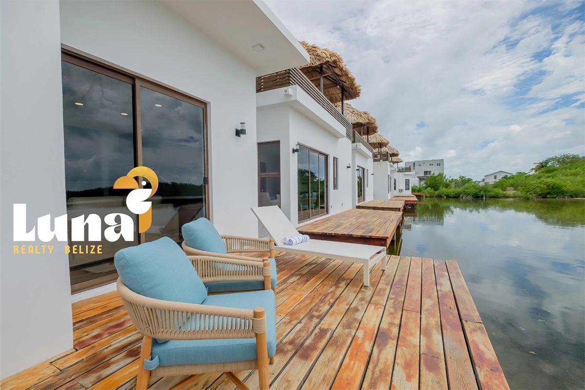 Waterfront villas with deck and seating.